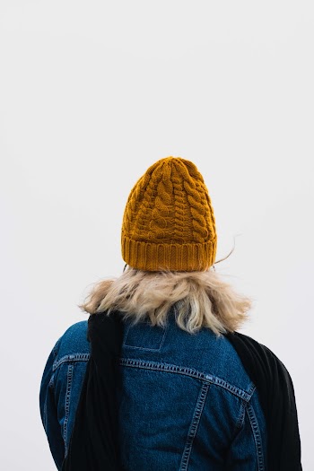 Back View Photo of Woman in Blue Denim Jacket and Mustard Beanie