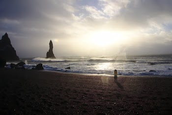 Back View Photo of Young Girl Standing Alone at the Beach Looking at the Horizon