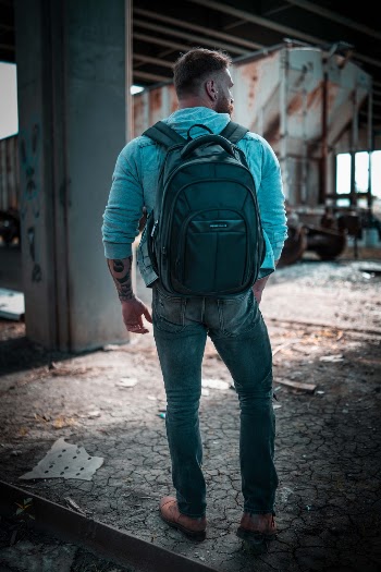 Backpack from Perry Ellis https://amzn.to/2VSdXVO. The photo was taken in Wichita, Kansas underneath the highway by the train tracks. It's a great spot as there is a lot of graffiti and some abandoned trains. 
