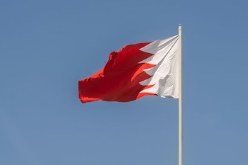 Bahrain National Flag Flying Against Clear Blue Sky