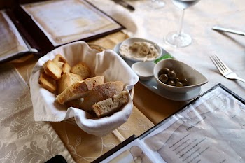 Baked Bread on Basket Besides White Ceramic Bowl