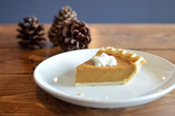 Baked Pie With Topping On White Ceramic Plate Near Brown Pine Cones