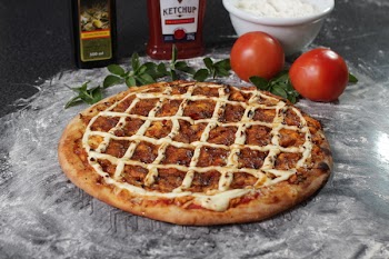 Baked Pizza Beside Two Red Tomatoes