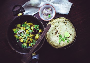 Baked Roti Topped With Sliced Lime Beside Onion Ring in White Bowl