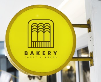 Bakery store's yellow shop sign mockup Free Psd