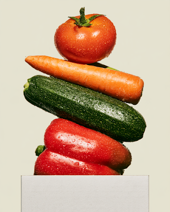 Balanced Stack of Fresh Vegetables in Minimalist Delivery Box