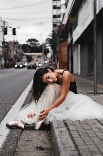 Ballerina Sitting on Sidewalk