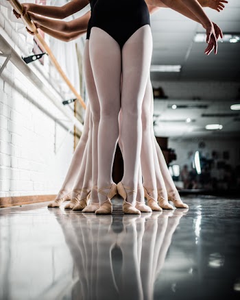 Ballerinas Fall in Line Holding Side Handles