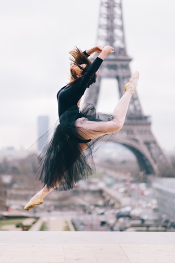 Ballet Dancer Performing Stunt With Eiffel Tower Background