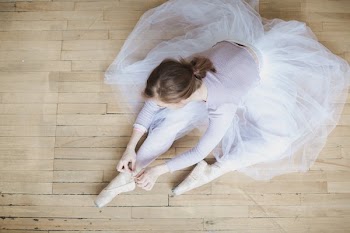 Ballet Dancer Ties Up Slippers