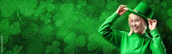 Banner with St. Patrick's Day leprechaun model girl on green magic background with shamrock leaves.