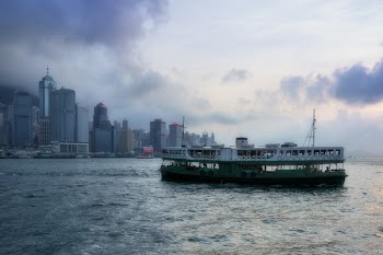 Barge on Body of Water Near High-rise Buildings