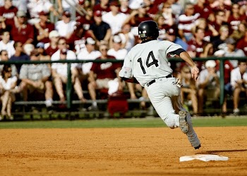 Baseball Player Number 14 Chasing Goal on Baseball Field
