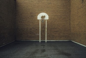 Basketball Ring Near Brown Brick Walls