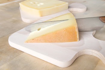 bavarian cheese with knife on a cutting board