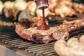 Bbq Sauce Going Onto Grilled Steak