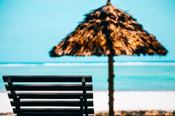 Beach Lounge Chair With Straw Parasol