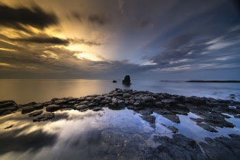 Beach Under Nimbus Clouds