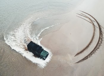 Beach vibes with a land rover and drone