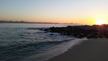 beach with rocks during golden hour