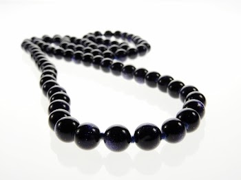 Beaded Black Necklace on White Surface