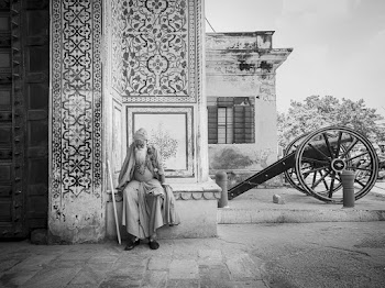 Bearded Man Sitting on Concrete Building Bench