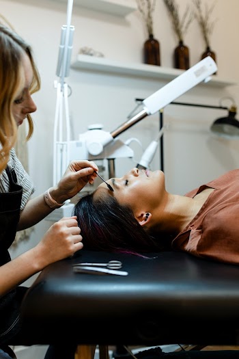 Beautician giving eyebrow treatment to a… | Free stock photo | High Resolution image