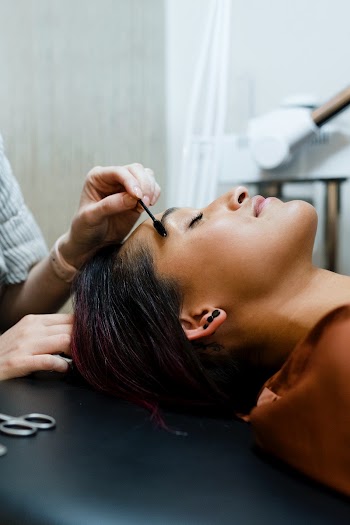 Beautician giving eyebrow treatment to a… | Free stock photo | High Resolution image