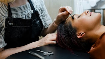 Beautician giving eyebrow treatment to a… | Free stock photo | High Resolution image