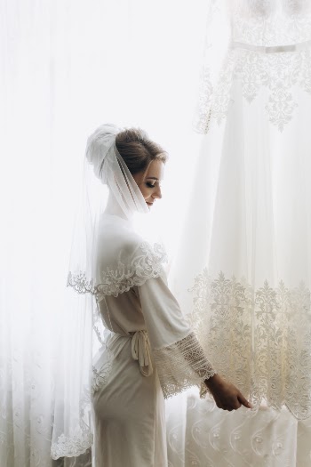 Beautiful bride, attractive woman in wedding dress. Happy newlywed woman. Bride with wedding makeup and hairstyle. Smiling bride. Wedding day. Gorgeous bride. Marriage.