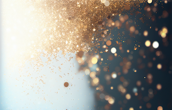 Beautiful Christmas light background. Abstract glitter bokeh and scattered sparkles in gold