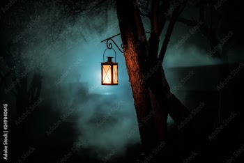 Beautiful colorful illuminated lamp in the garden in misty night. Retro style lantern at night outdoor.