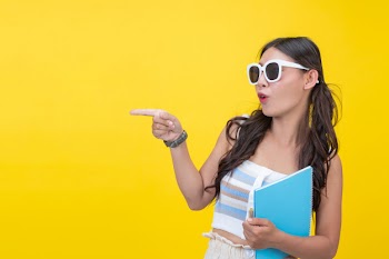 Beautiful female students hold notebooks and pens Free Photo