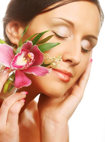 Beautiful girl holding orchid flower in her hands