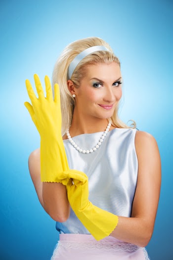 Beautiful happy housewife with rubber gloves