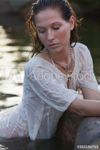 Beautiful serene young woman in lake