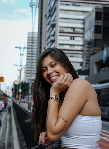 Beautiful woman wearing a white top near buildings