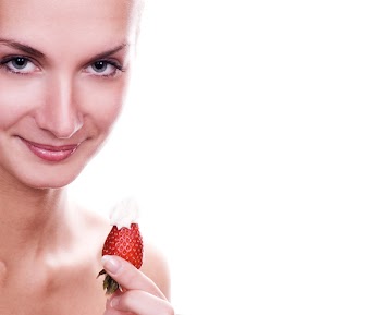 Beautiful young naked girl with red juicy strawberry