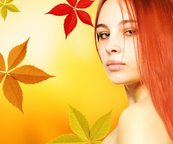 Beautiful young woman over abstract autumn background