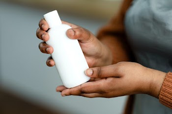 Beauty product bottle being carried  | Free stock photo | High Resolution image