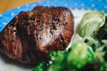 Beef steak with black salt close up 