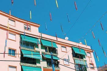 Beige Building With Teal Awnings