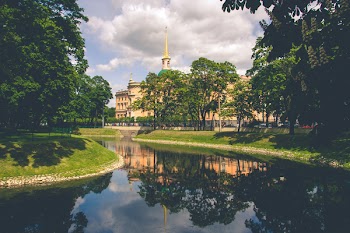 Beige Castle Near Trees and Body of Water