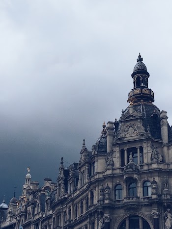 Beige Concrete Building and White Clouds