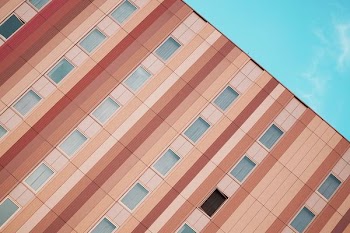 beige concrete building under blue sky
