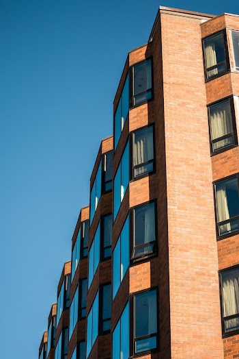 Beige Concrete High-rise Building Under Blue Sky