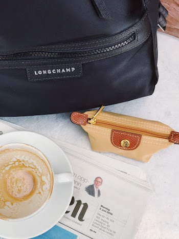 Beige Handbag Near Cup on Saucer