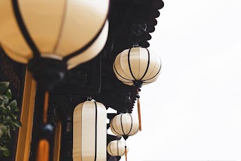 beige lantern hanging near house