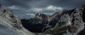 beige mountain under cloudy sky