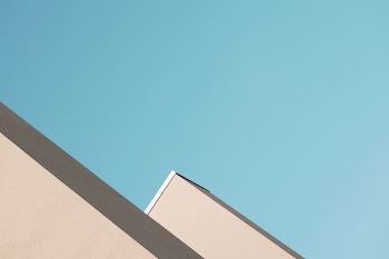 beige painted building under blue sky